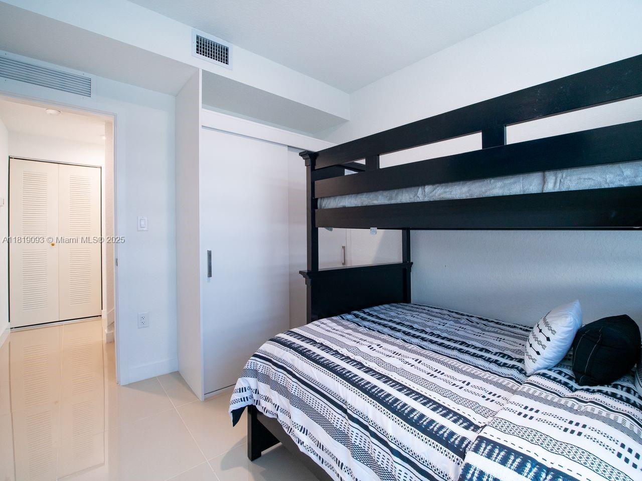 25718 Southwest 143rd Path Homestead, FL 33032 - Photo 17 of 26 a bedroom with a bed and a window