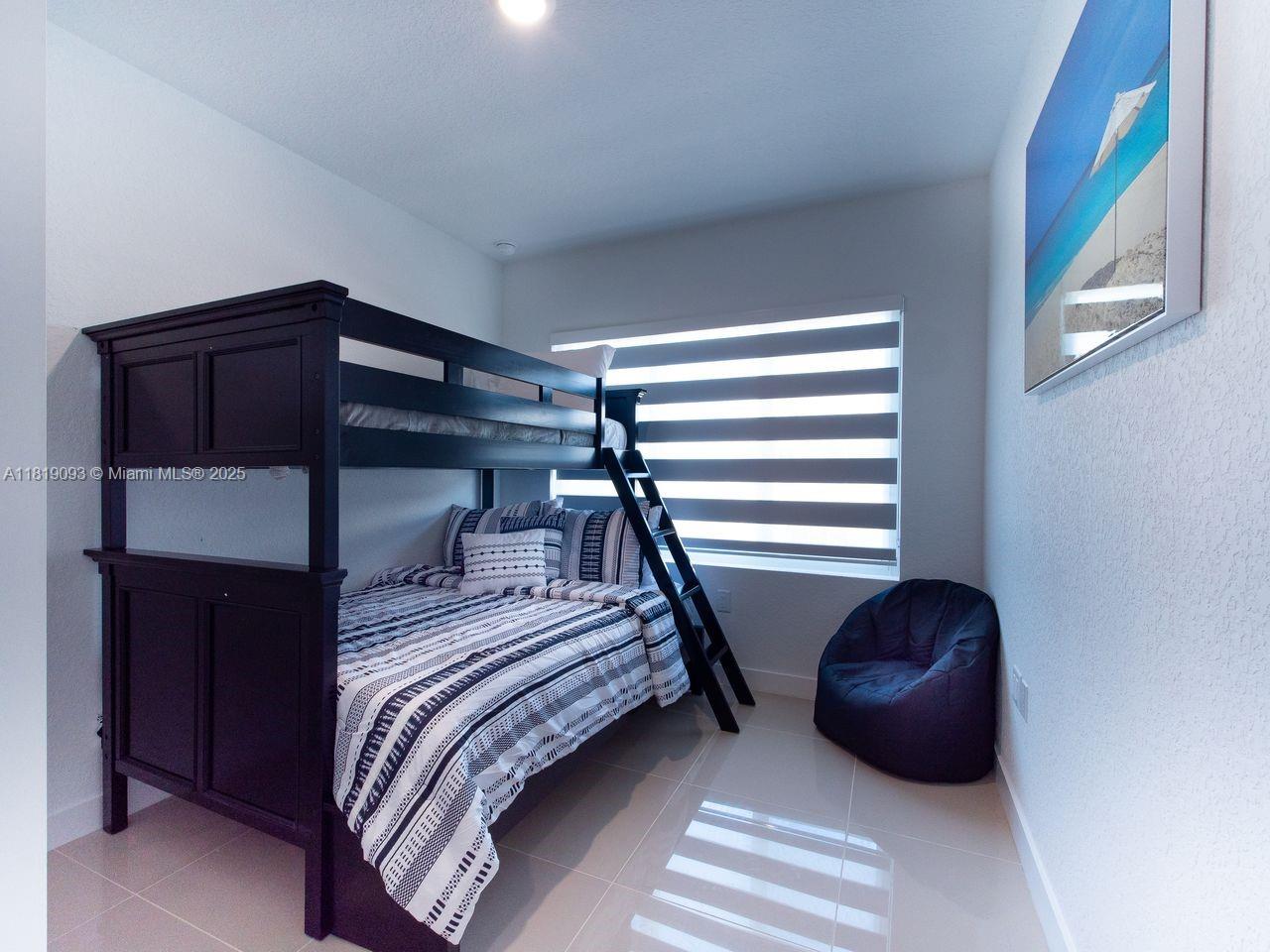 25718 Southwest 143rd Path Homestead, FL 33032 - Photo 18 of 26 a bedroom with a bed and a window