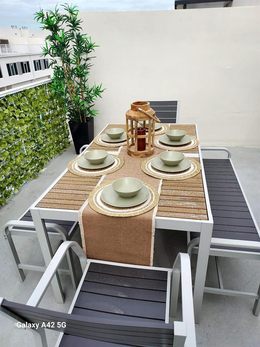 25718 Southwest 143rd Path Homestead, FL 33032 - Photo 20 of 26 a dining room with furniture and wooden floor