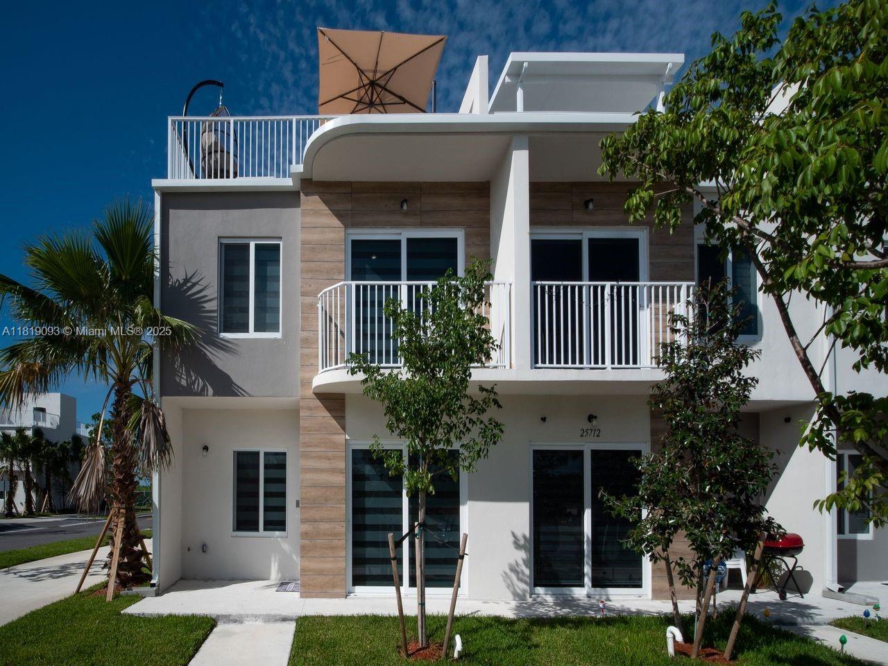 25718 Southwest 143rd Path Homestead, FL 33032 - Photo 2 of 26 a front view of a house with a garden