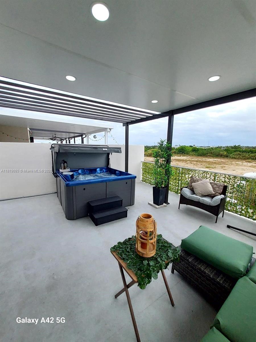 25718 Southwest 143rd Path Homestead, FL 33032 - Photo 23 of 26 a living room with furniture and floor to ceiling window