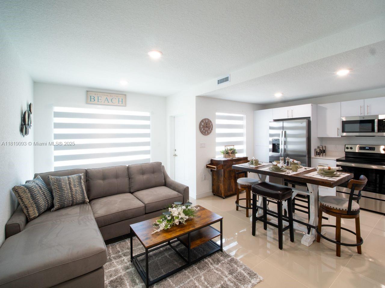 25718 Southwest 143rd Path Homestead, FL 33032 - Photo 3 of 26 a living room with furniture a rug and a window
