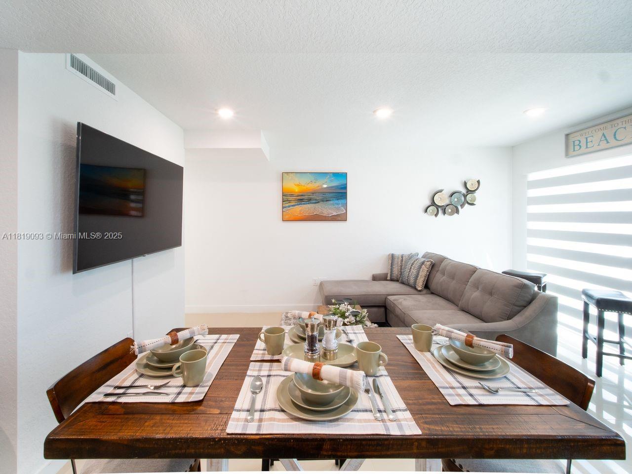 25718 Southwest 143rd Path Homestead, FL 33032 - Photo 4 of 26 a living room with furniture and a flat screen tv