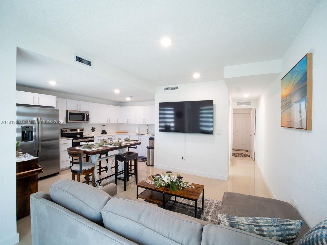 25718 Southwest 143rd Path Homestead, FL 33032 - Photo 6 of 26 a living room with furniture kitchen view and a window