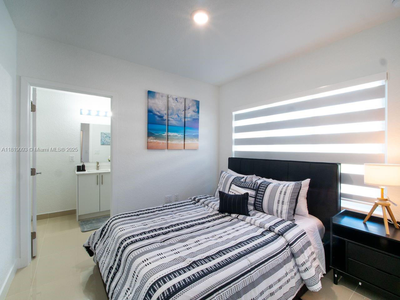 25718 Southwest 143rd Path Homestead, FL 33032 - Photo 9 of 26 a bedroom with a bed and a window