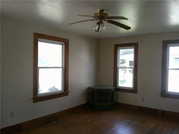 a living room with hardwood floor and a window