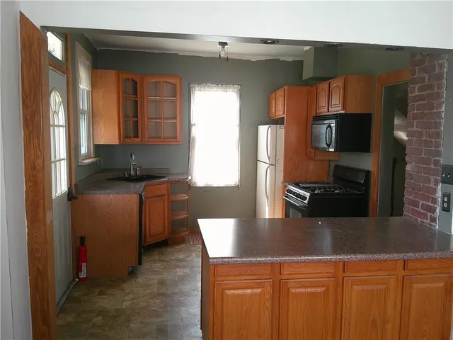 a kitchen with a sink and a refrigerator