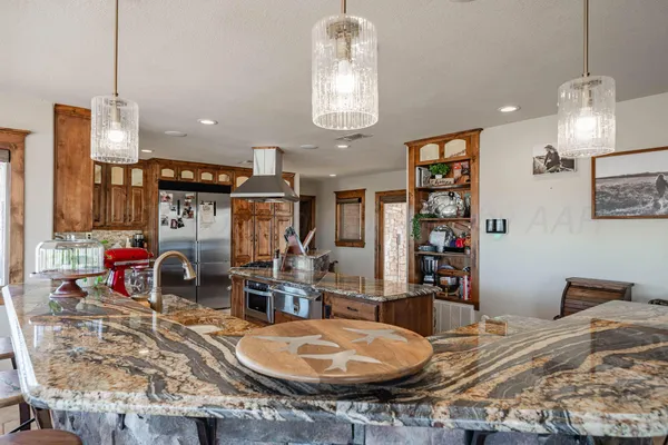 a kitchen with stainless steel appliances granite countertop a stove and a refrigerator