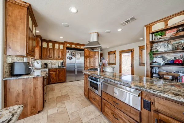 a kitchen with sink a stove and a microwave oven