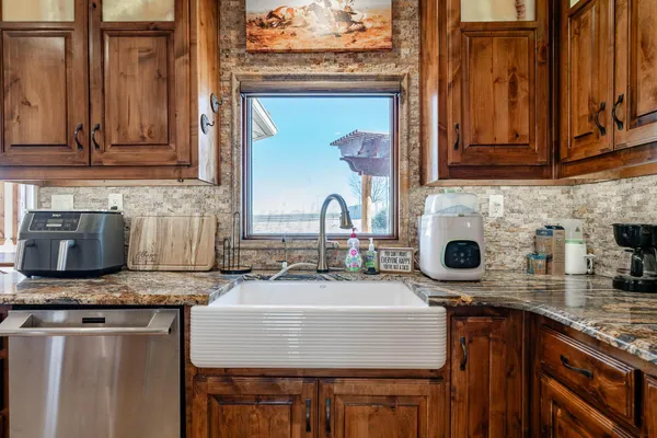 a kitchen with stainless steel appliances granite countertop a stove and a sink