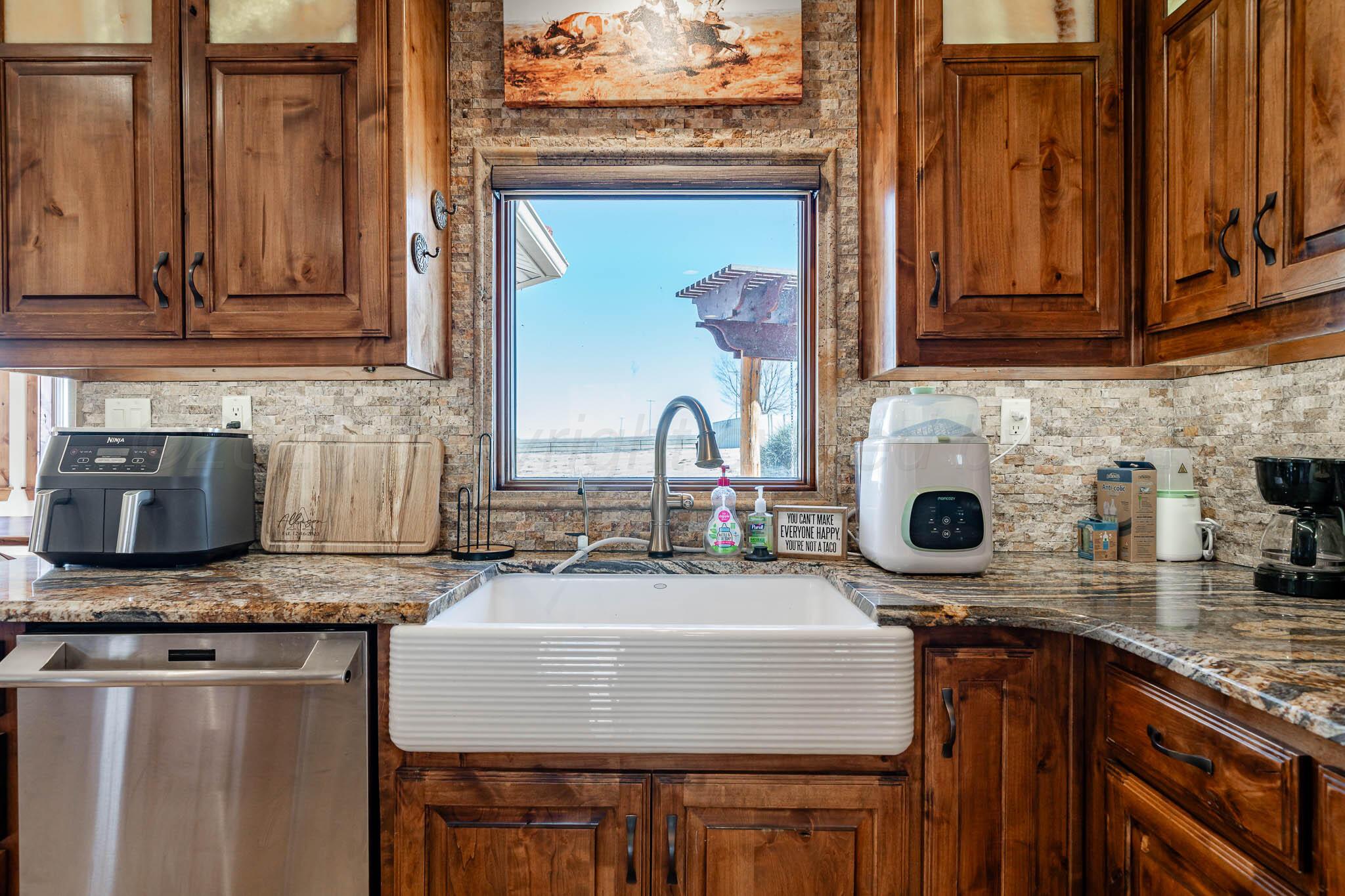 1000 Osage Street Wheeler, TX 79096 - Photo 21 of 57 a kitchen with sink a stove and a microwave oven