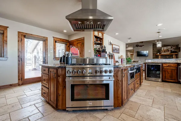 a kitchen with stainless steel appliances a stove a refrigerator and cabinets