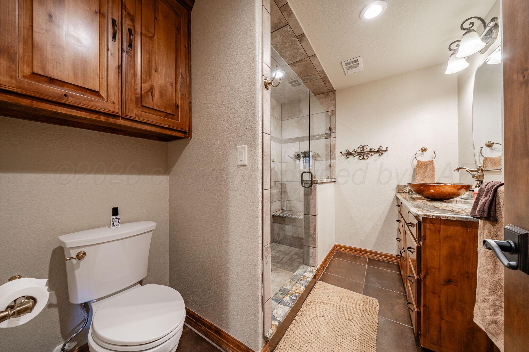 1000 Osage Street Wheeler, TX 79096 - Photo 27 of 57 a bathroom with a toilet a sink and shower