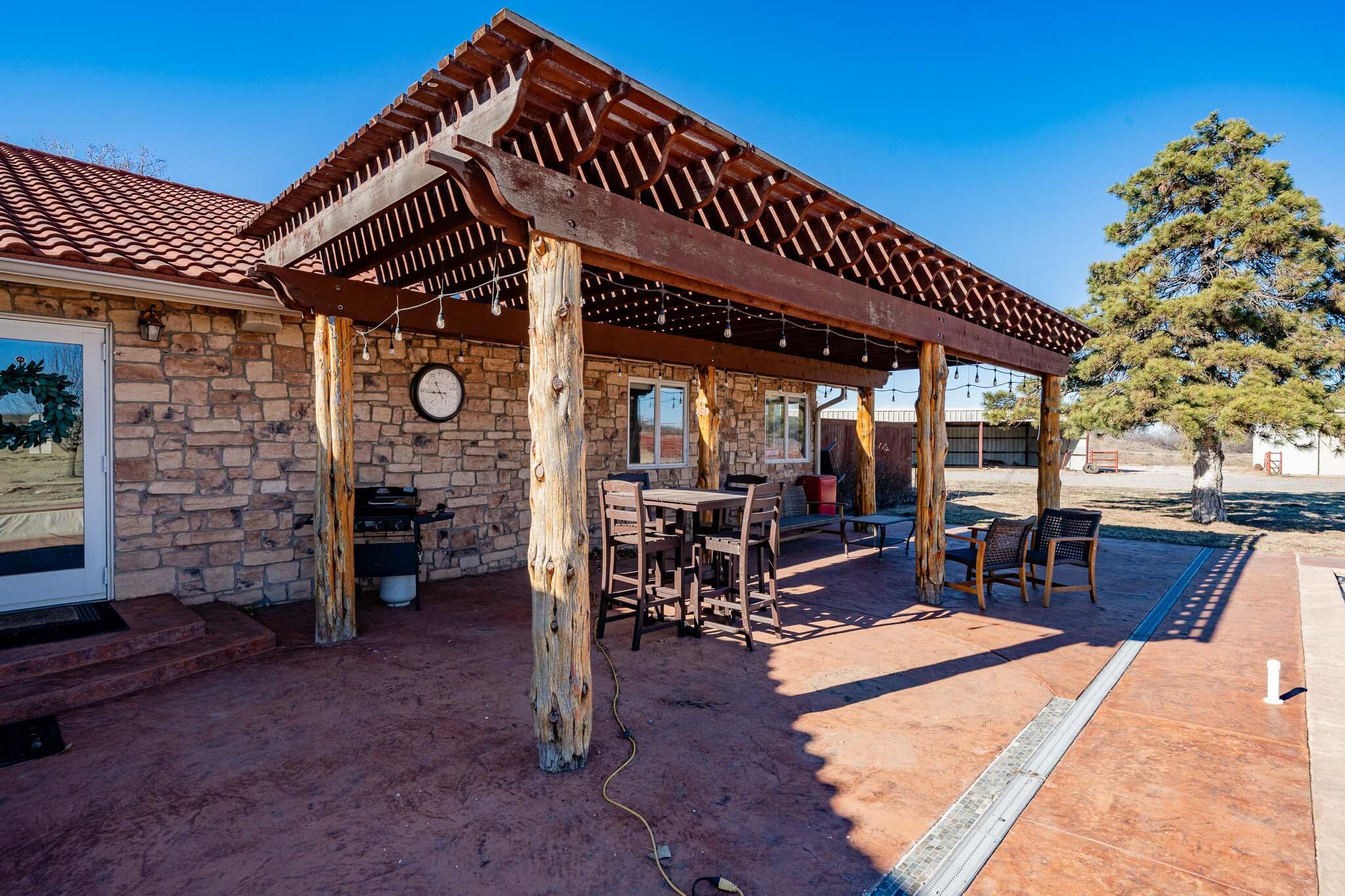 1000 Osage Street Wheeler, TX 79096 - Photo 41 of 57 a view of a patio with a table and chairs under an umbrella