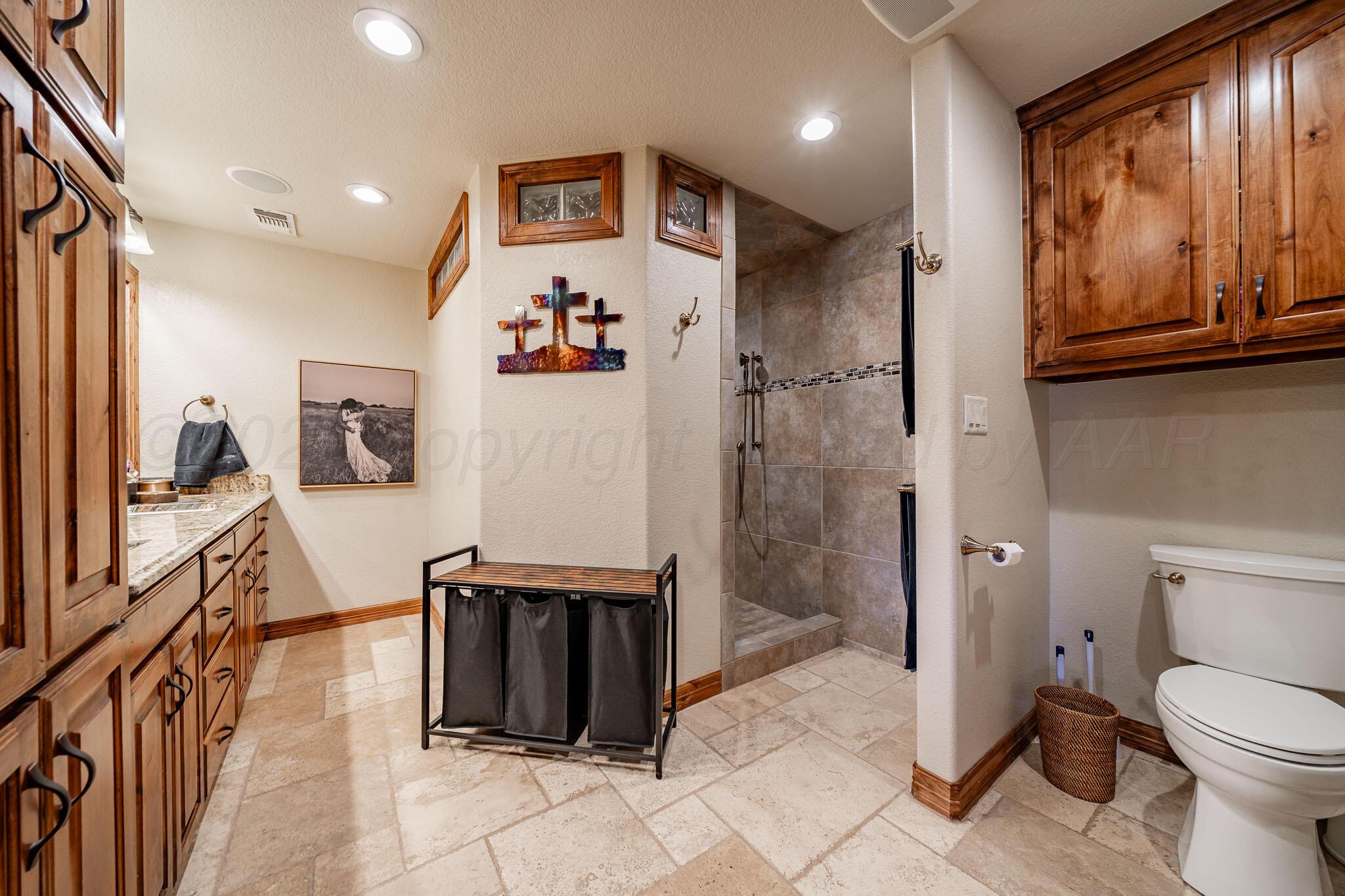 1000 Osage Street Wheeler, TX 79096 - Photo 10 of 57 a spacious bathroom with a toilet a sink and a shower
