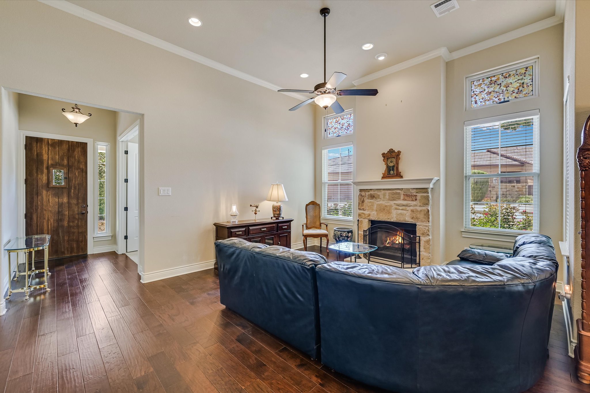 103 Rivalto Circle, Unit 1 Lakeway, TX 78734 - Photo 3 of 34 Living room with high ceilings, hardwood floors and a fireplace