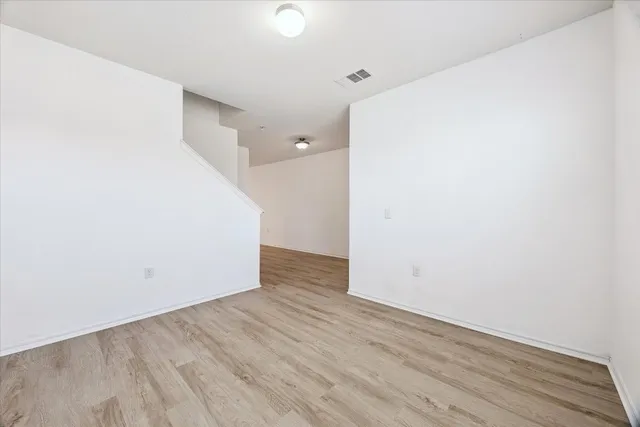 a view of a room with wooden floor