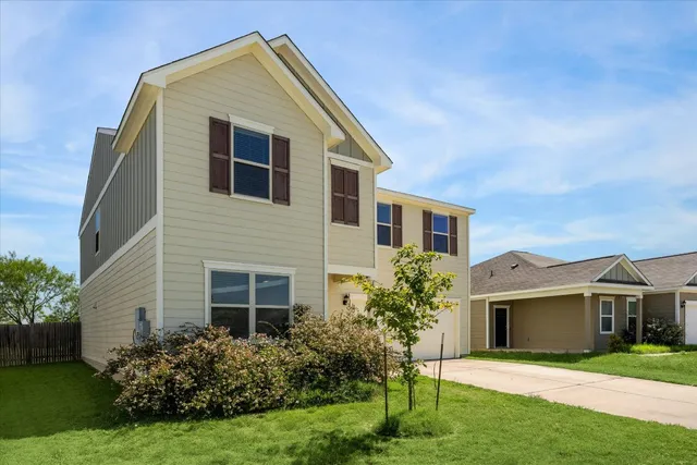 a front view of house with yard and green space
