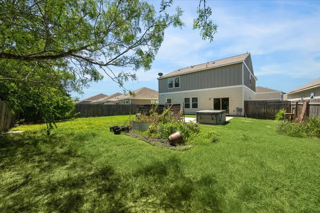 a view of a house with a backyard