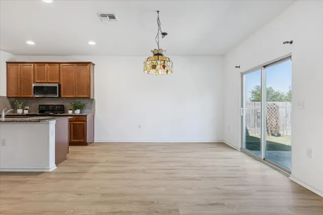 a room with wooden floor and a window