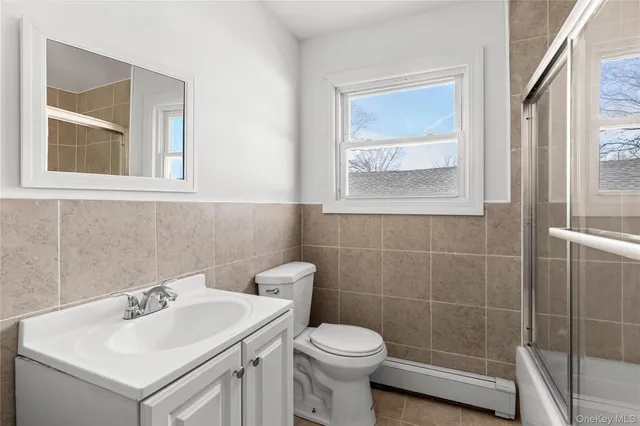 a bathroom with a sink toilet and window