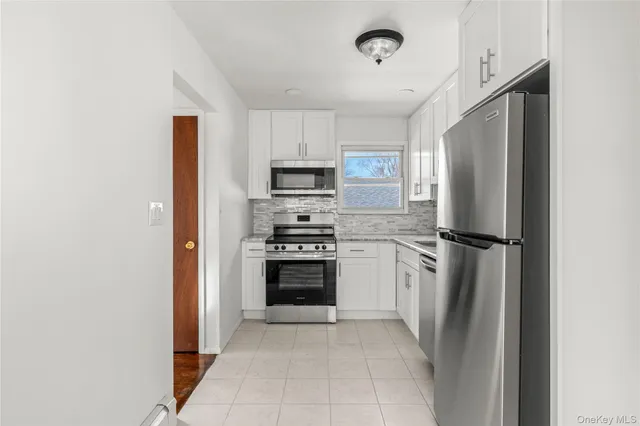 a kitchen with stainless steel appliances a refrigerator sink and microwave