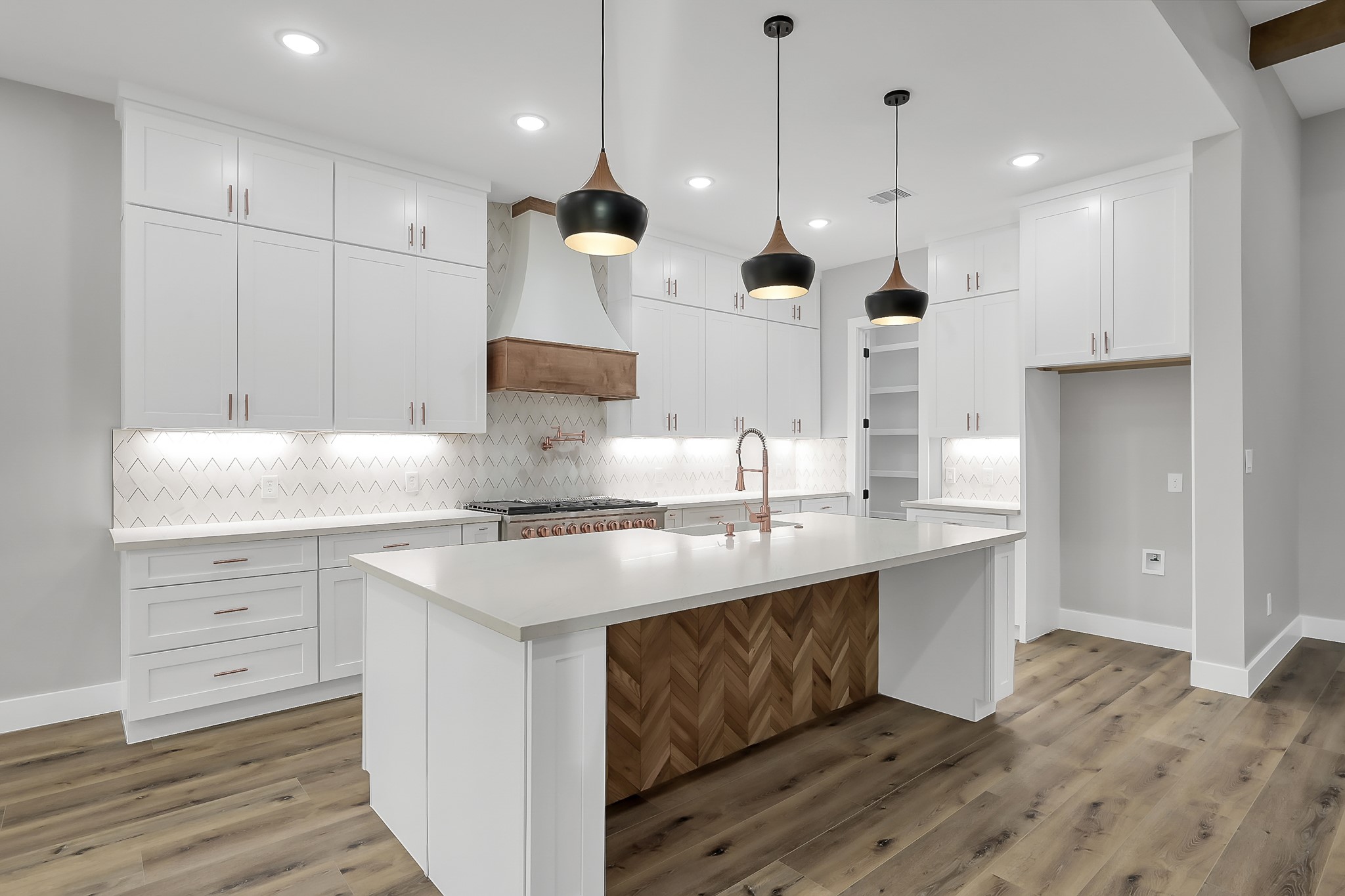 135 Wick Willow Road Montgomery, TX 77356 - Photo 11 of 48 a kitchen with kitchen island a sink stainless steel appliances and cabinets