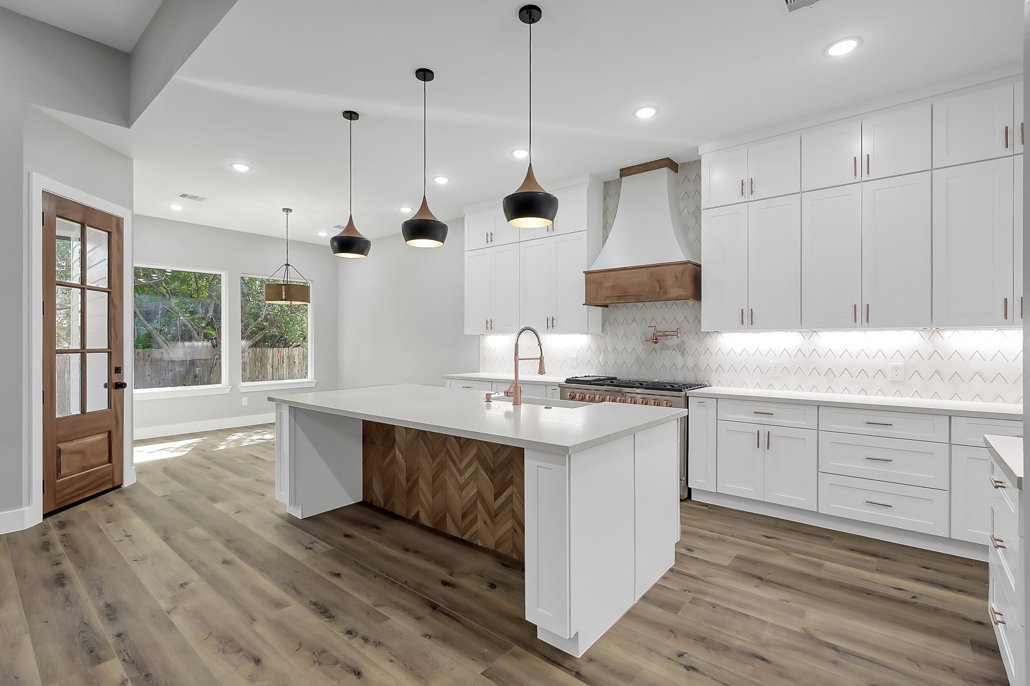 135 Wick Willow Road Montgomery, TX 77356 - Photo 14 of 48 a kitchen with stainless steel appliances granite countertop a sink a stove and a wooden floors