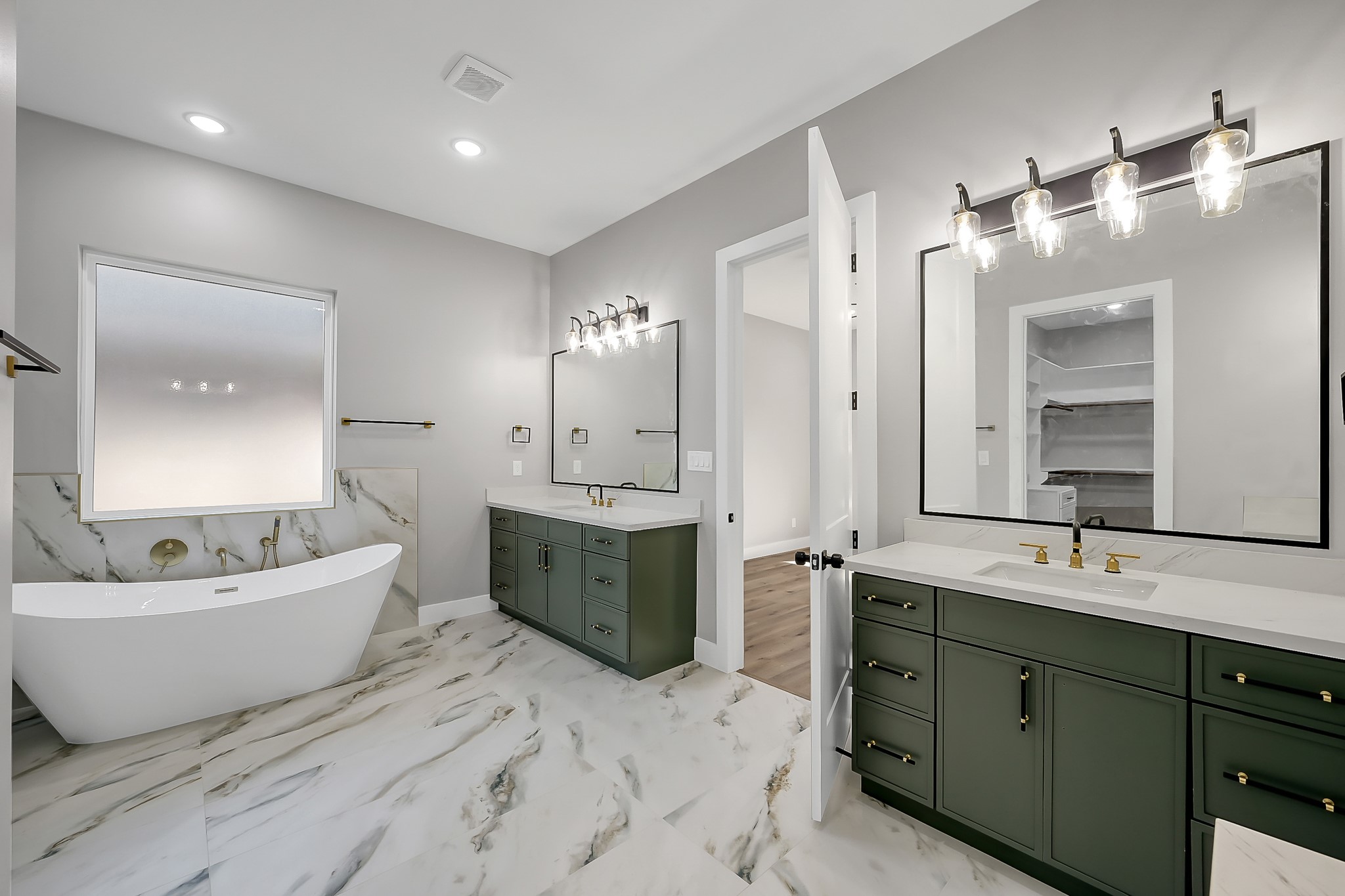 135 Wick Willow Road Montgomery, TX 77356 - Photo 29 of 48 a spacious bathroom with a double vanity sink a large mirror and bathtub