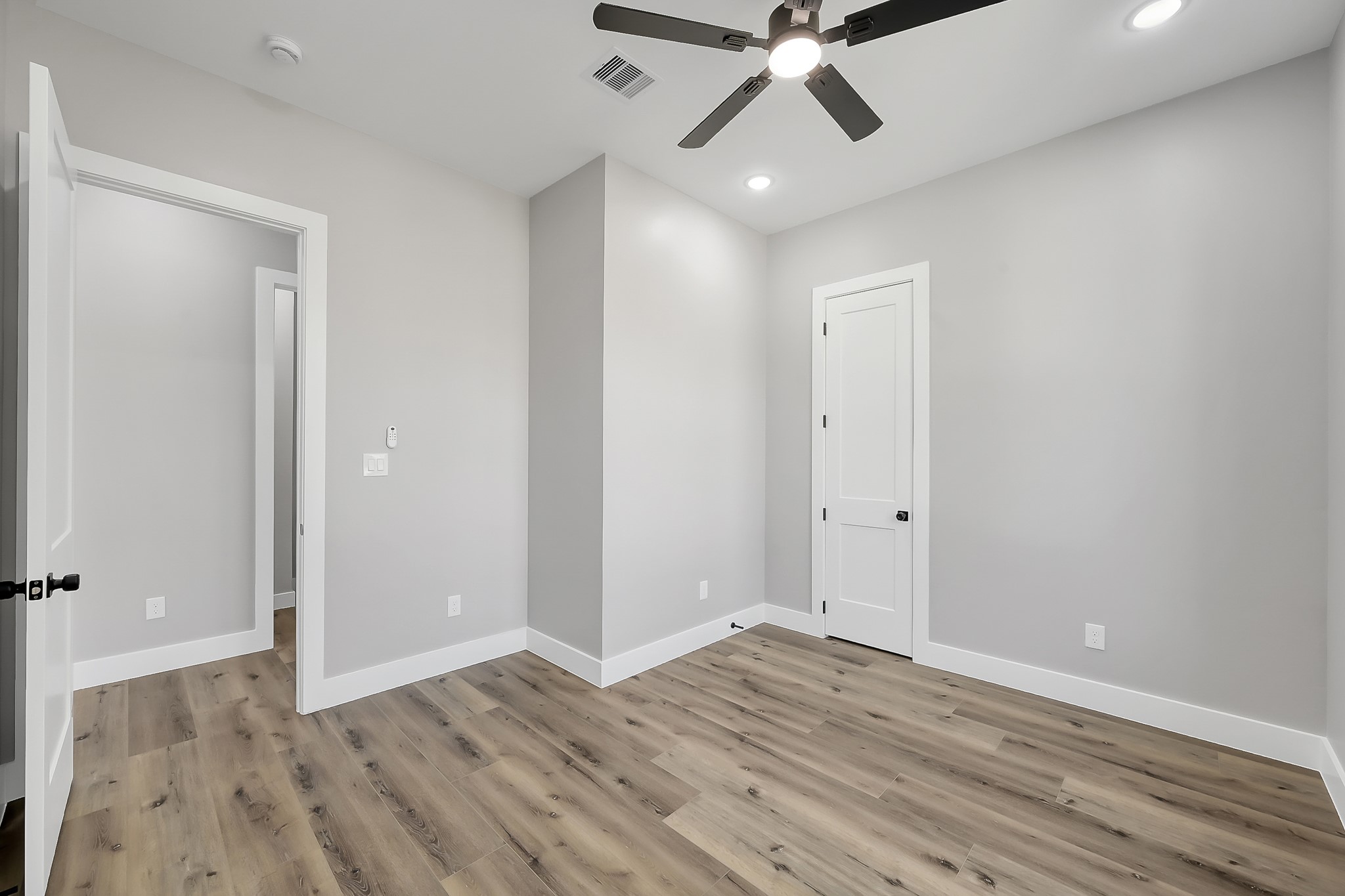 135 Wick Willow Road Montgomery, TX 77356 - Photo 32 of 48 an empty room with wooden floor and windows