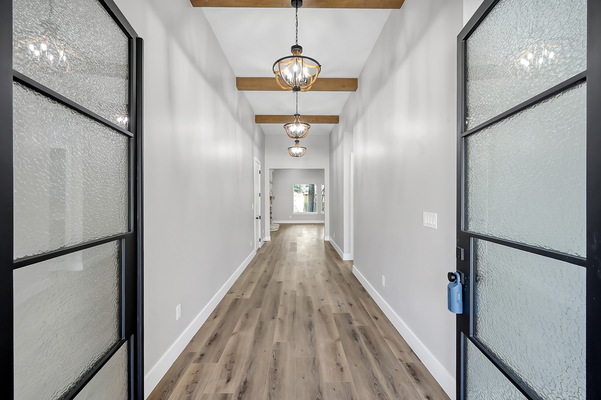 135 Wick Willow Road Montgomery, TX 77356 - Photo 4 of 48 a view of a hallway with wooden floor and staircase