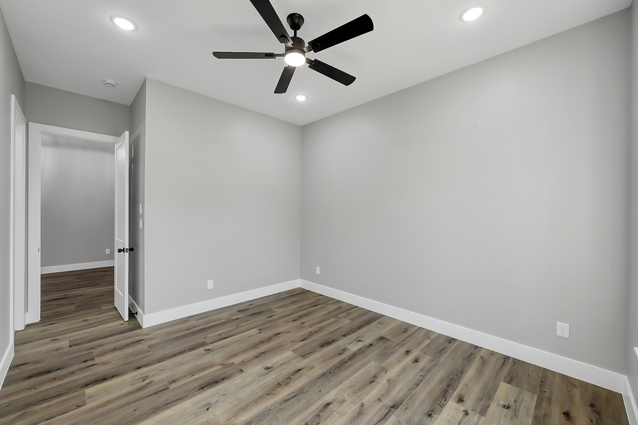 135 Wick Willow Road Montgomery, TX 77356 - Photo 41 of 48 an empty room with wooden floor and a ceiling fan