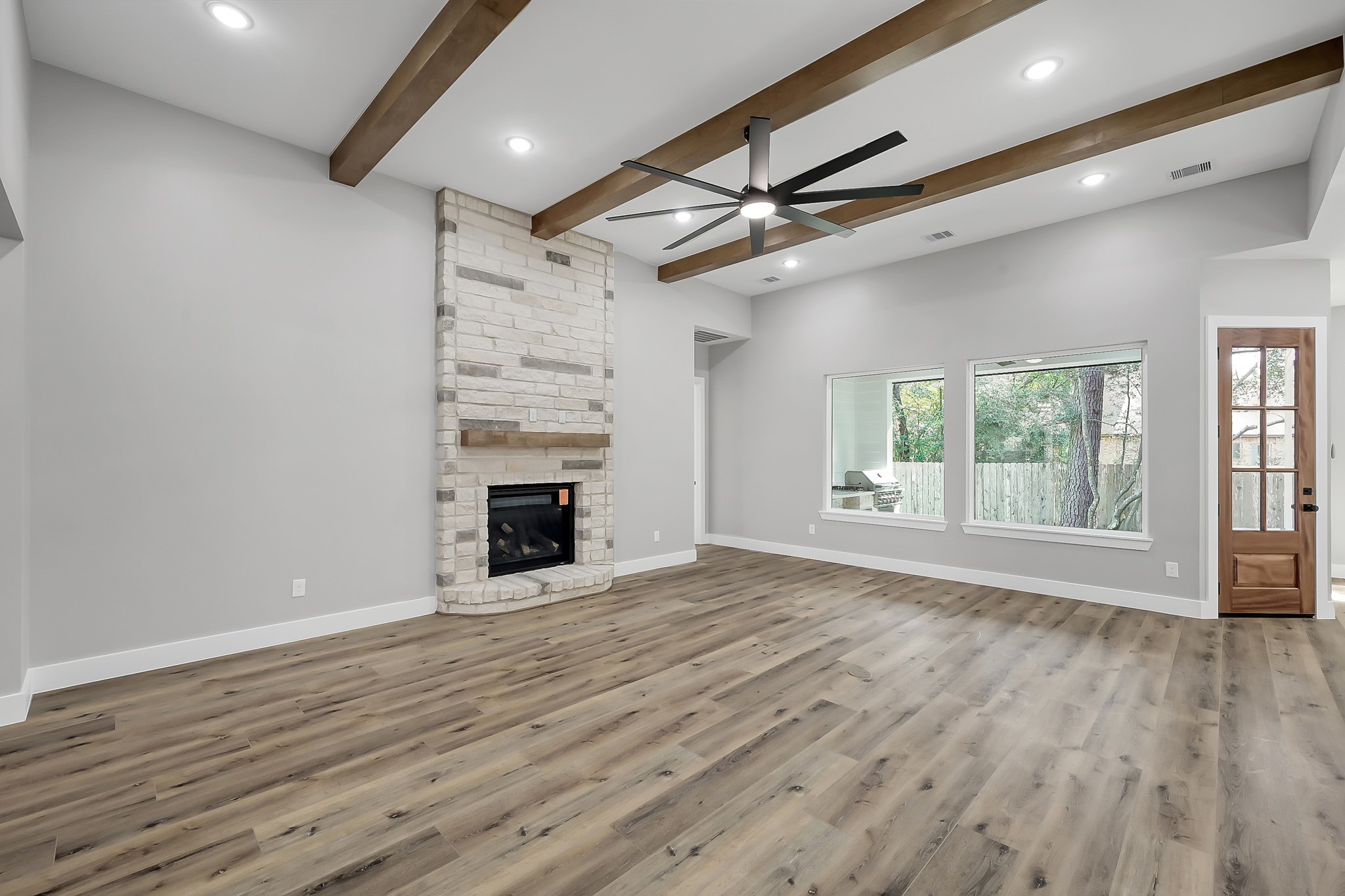 135 Wick Willow Road Montgomery, TX 77356 - Photo 8 of 48 a view of an empty room with wooden floor fireplace and a window