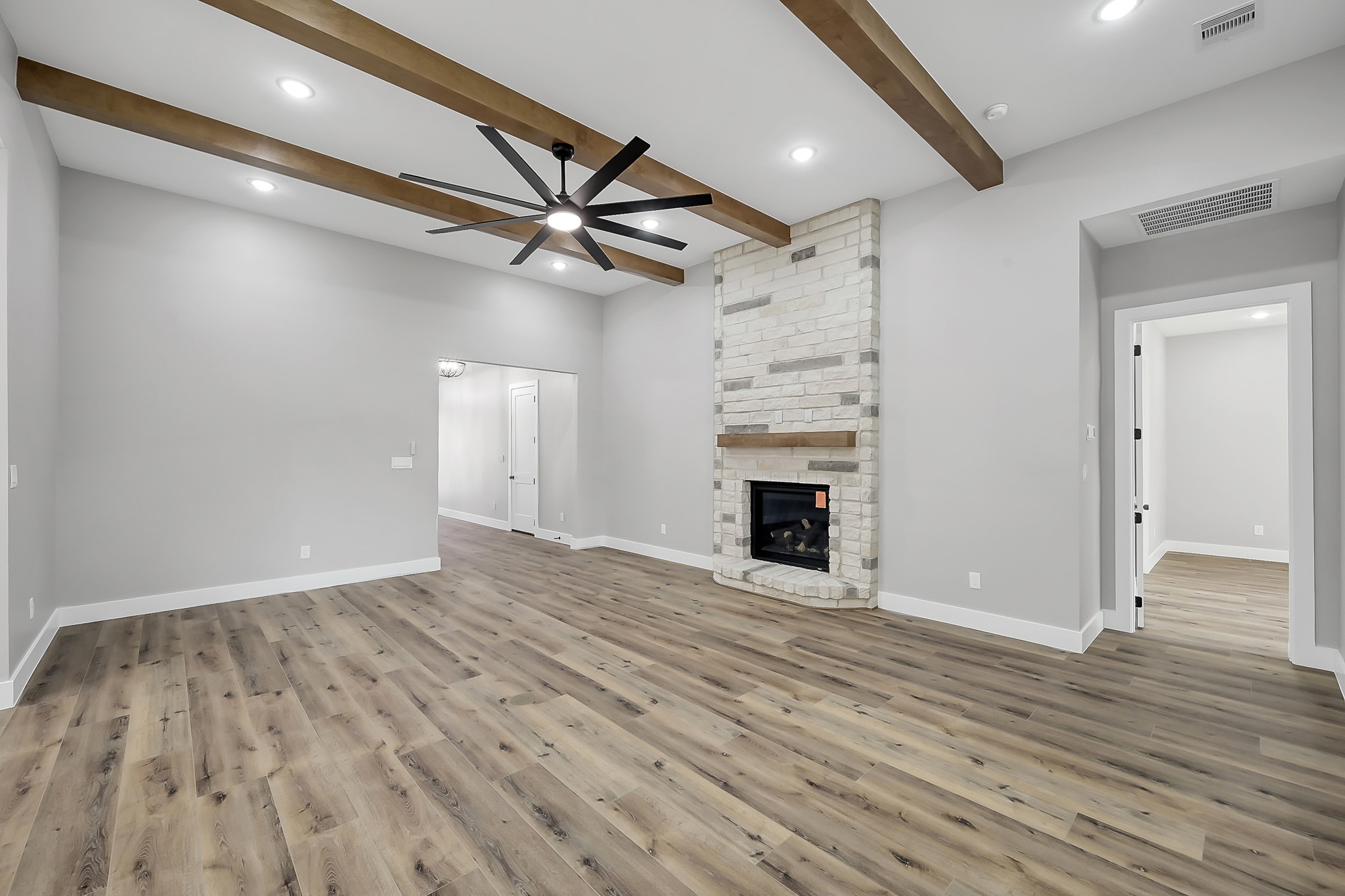 135 Wick Willow Road Montgomery, TX 77356 - Photo 9 of 48 wooden floor in an empty room with a fireplace