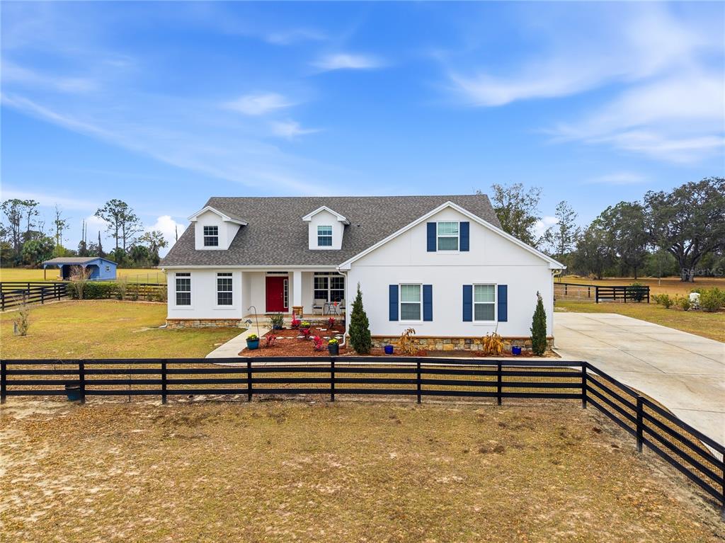 a backyard of a house with wooden floor and fence