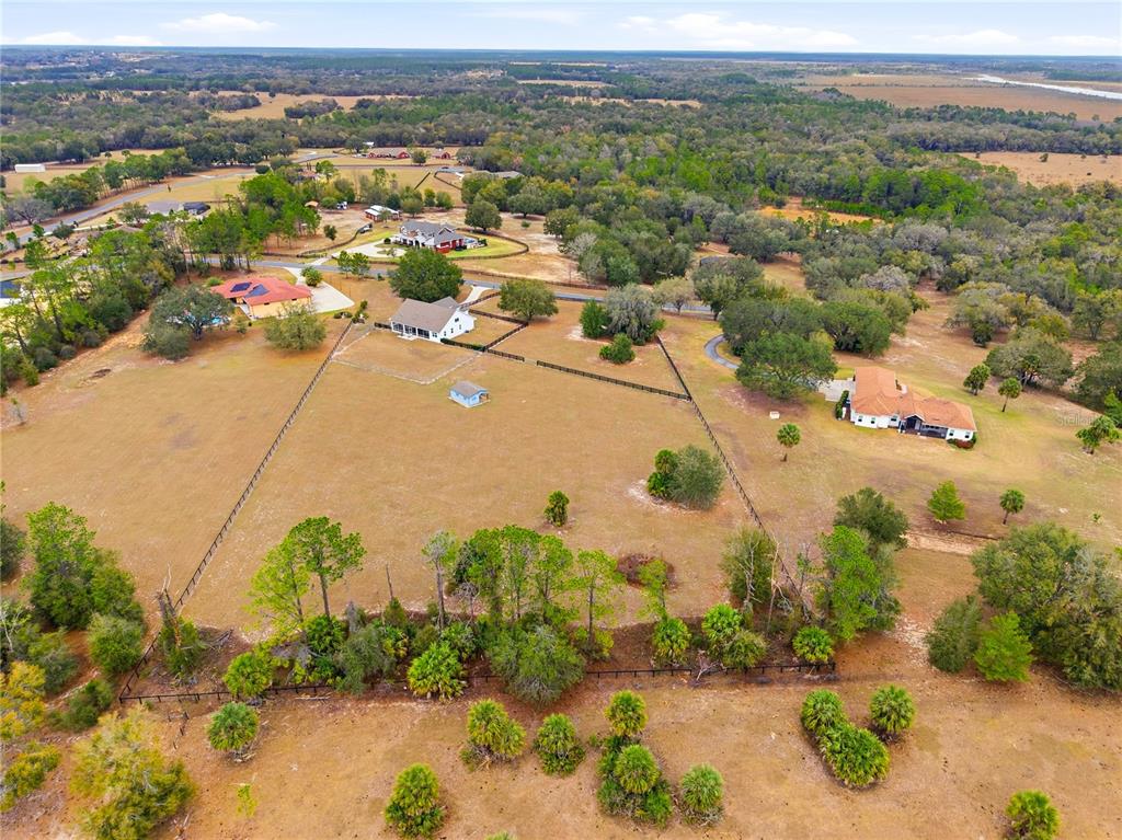 5608 Strong Point Weirsdale, FL 32195 - Photo 14 of 56 an aerial view of a city with lots of residential buildings ocean and mountain view in back