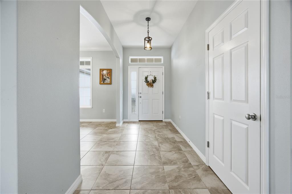 5608 Strong Point Weirsdale, FL 32195 - Photo 22 of 56 a view of a hallway view with wooden floor and staircase