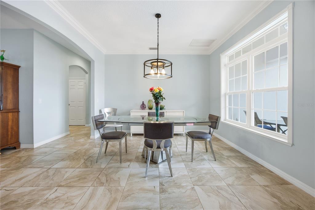 5608 Strong Point Weirsdale, FL 32195 - Photo 23 of 56 a view of a dining room with furniture window and wooden floor
