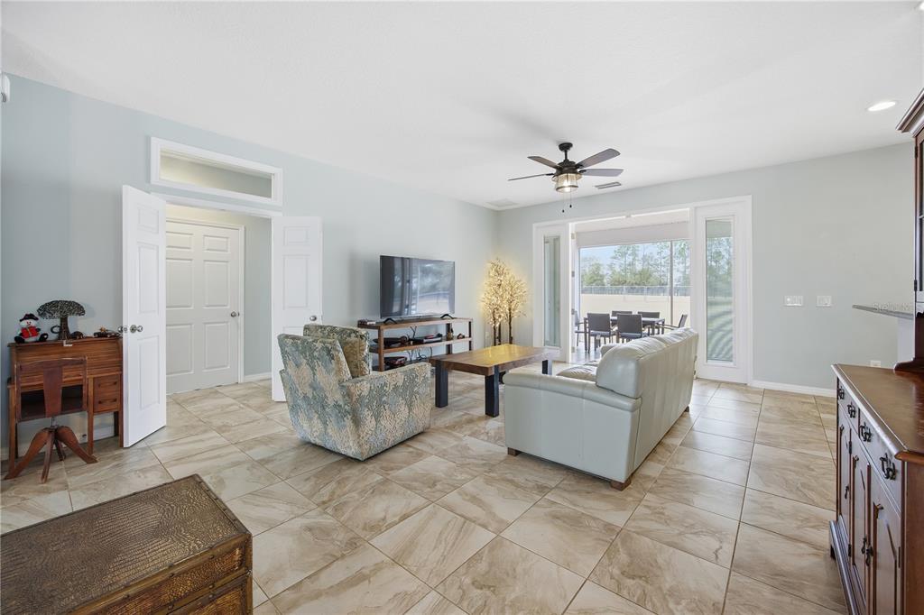 5608 Strong Point Weirsdale, FL 32195 - Photo 25 of 56 a living room with furniture and a flat screen tv