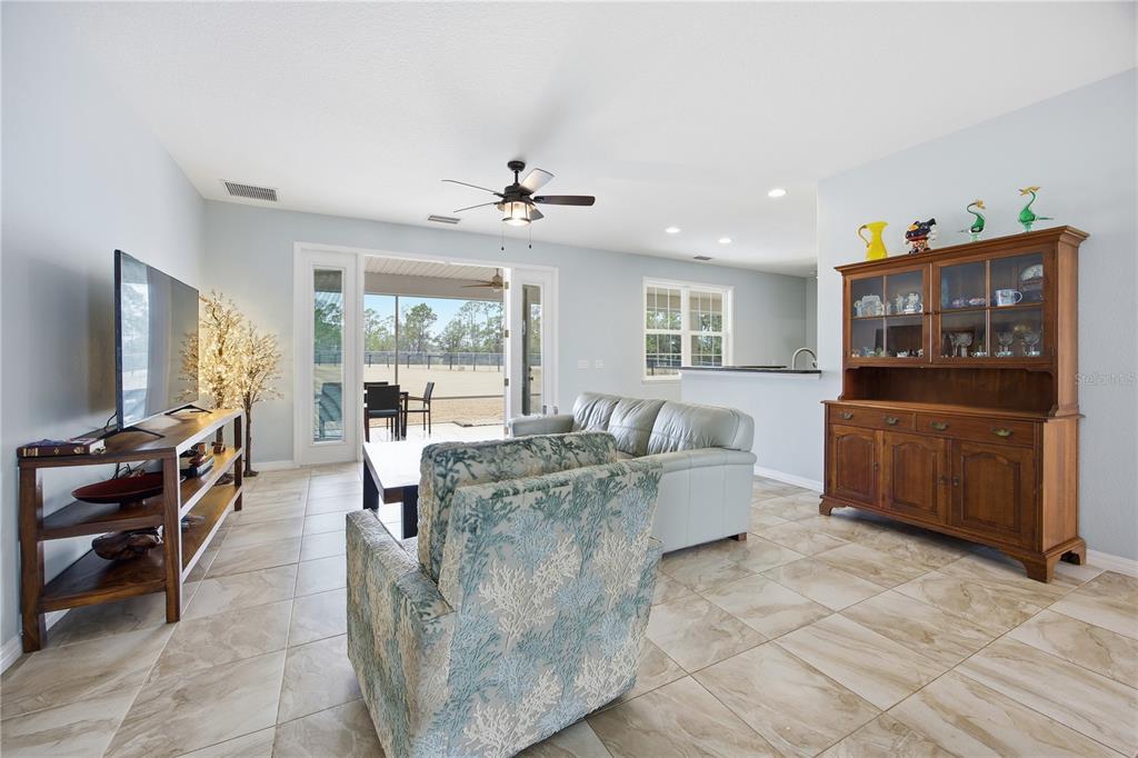 5608 Strong Point Weirsdale, FL 32195 - Photo 26 of 56 a living room with furniture and a flat screen tv