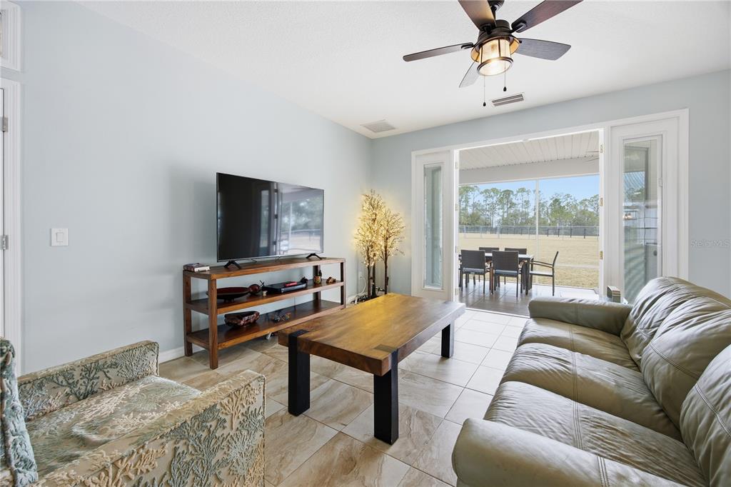 5608 Strong Point Weirsdale, FL 32195 - Photo 27 of 56 a living room with furniture and a flat screen tv