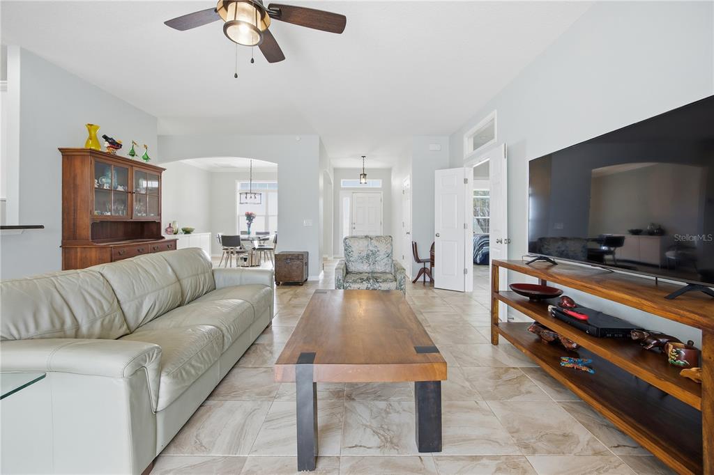 5608 Strong Point Weirsdale, FL 32195 - Photo 28 of 56 a living room with furniture and a flat screen tv