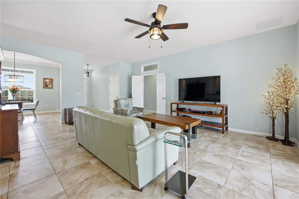 5608 Strong Point Weirsdale, FL 32195 - Photo 29 of 56 a living room with furniture and a flat screen tv