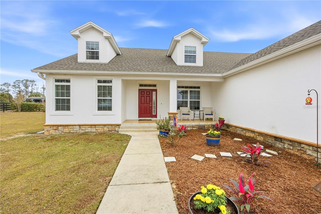 5608 Strong Point Weirsdale, FL 32195 - Photo 3 of 56 a front view of a house with a yard