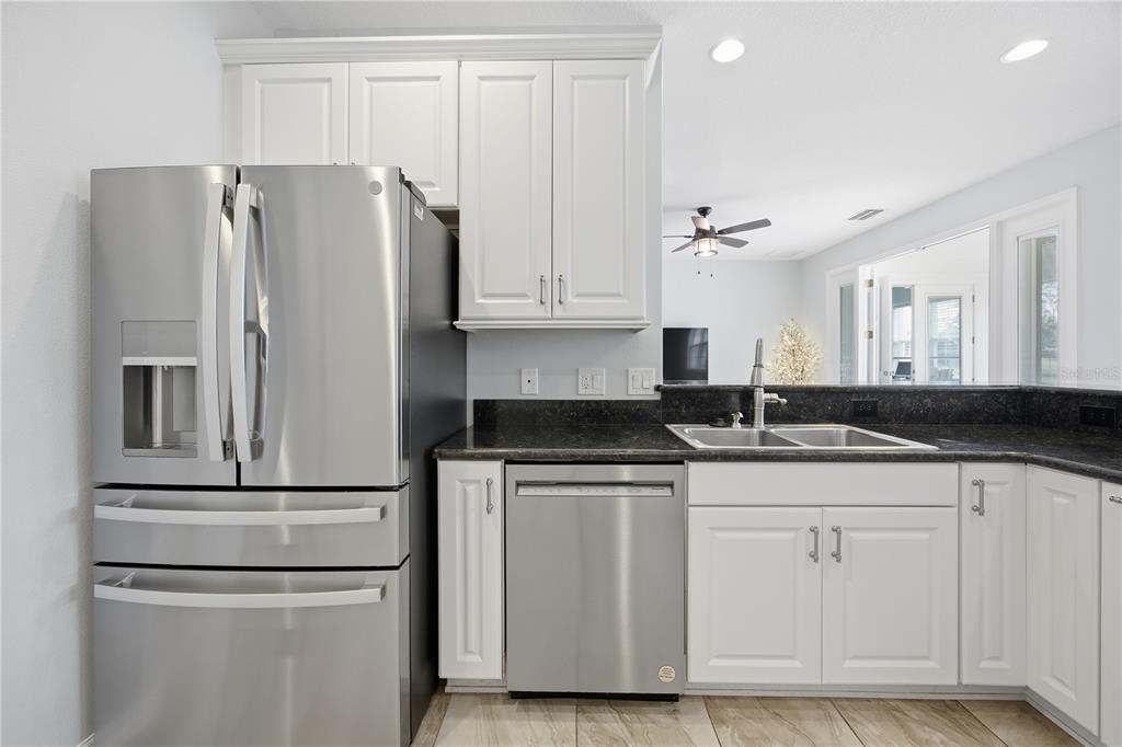 5608 Strong Point Weirsdale, FL 32195 - Photo 32 of 56 a kitchen with cabinets and stainless steel appliances