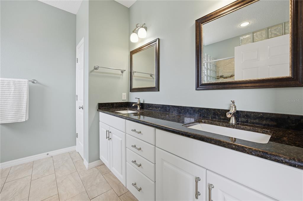 5608 Strong Point Weirsdale, FL 32195 - Photo 36 of 56 a bathroom with a sink and a mirror