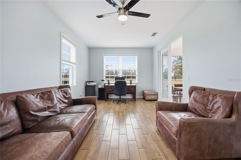 5608 Strong Point Weirsdale, FL 32195 - Photo 42 of 56 a living room with furniture and a large window