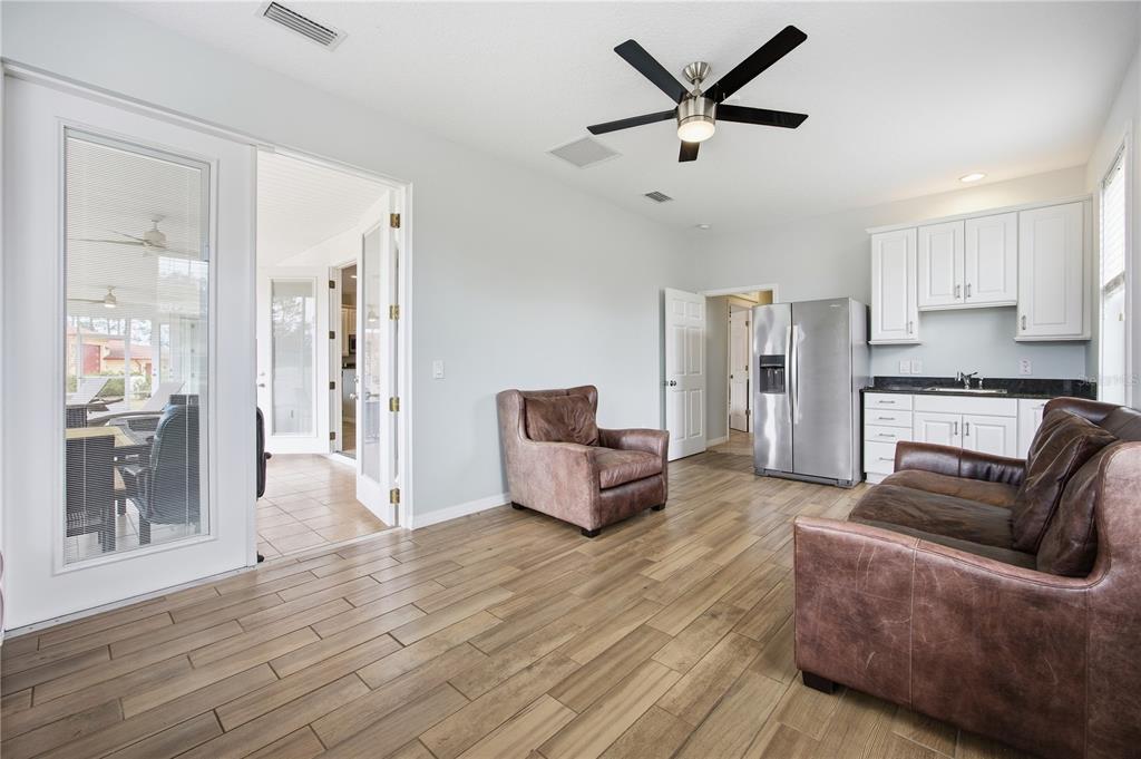 5608 Strong Point Weirsdale, FL 32195 - Photo 43 of 56 a living room with furniture and a wooden floor