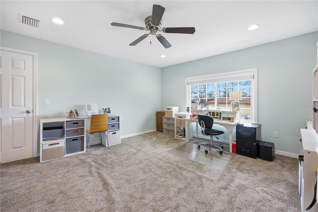 5608 Strong Point Weirsdale, FL 32195 - Photo 45 of 56 a view of a workspace with furniture and a window