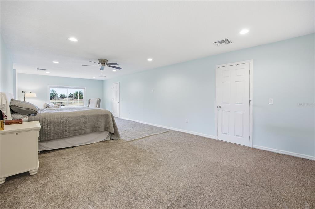 5608 Strong Point Weirsdale, FL 32195 - Photo 48 of 56 a bedroom with bed and a couch